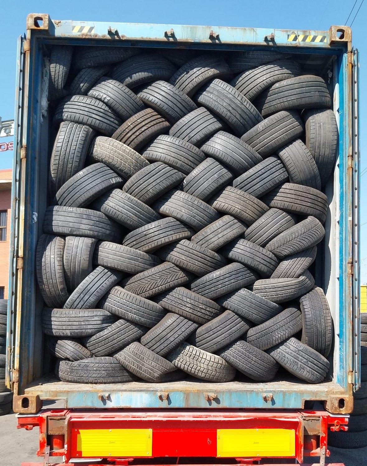 Container loaded with laced used tires